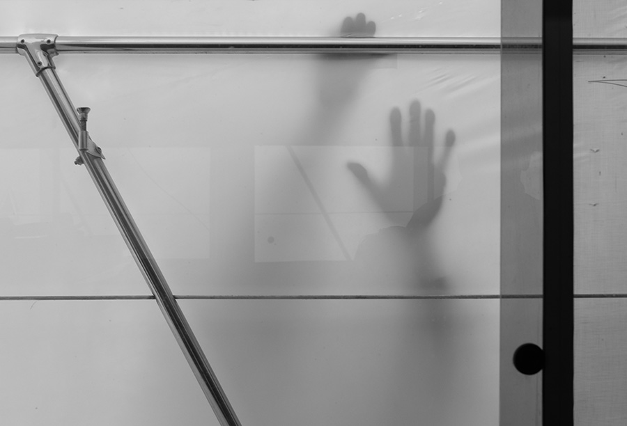 Black and White of Shadowy Hands Through Translucent Plastic.